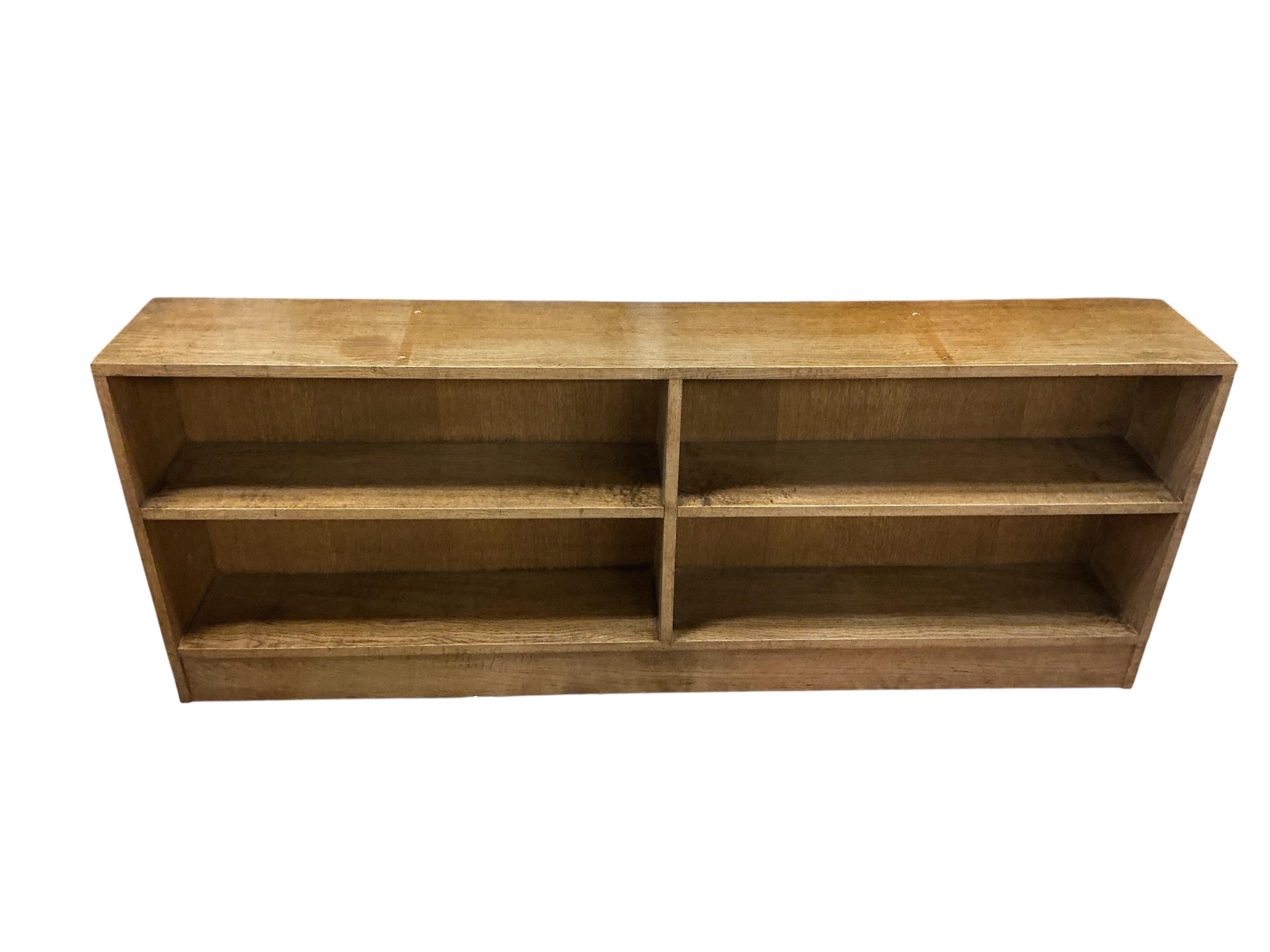 A mid century oak dwarf open bookcase, width 176cm, depth 27cm, height 67cm
